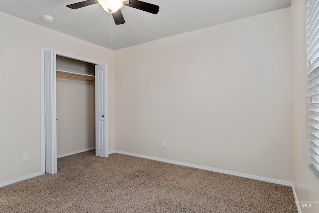 unfurnished bedroom featuring carpet flooring, ceiling fan, and a closet