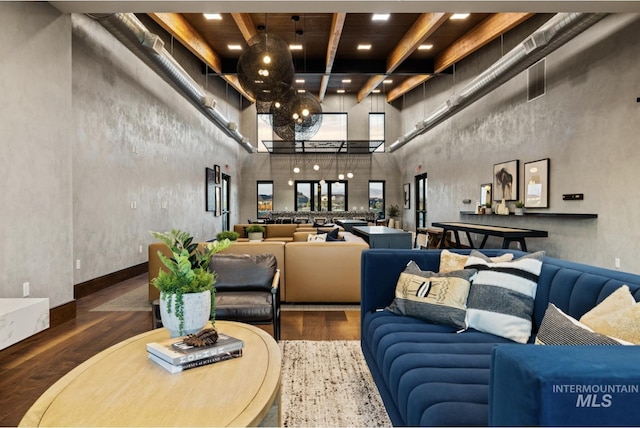 common area featuring a towering ceiling, beam ceiling, recessed lighting, and wooden ceiling