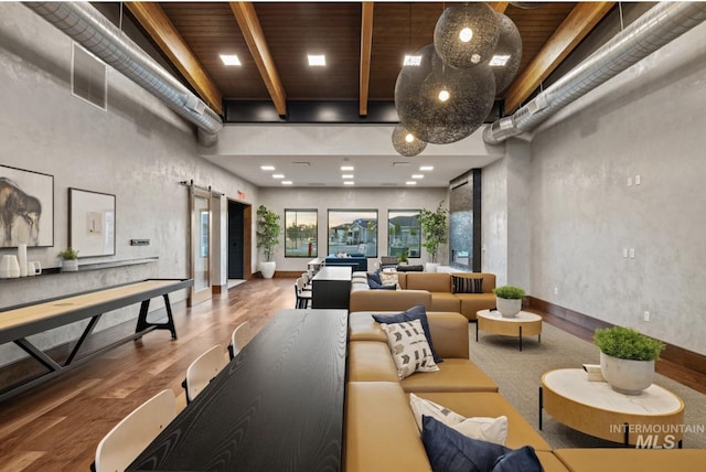 community lobby featuring beam ceiling, a high ceiling, and wooden ceiling