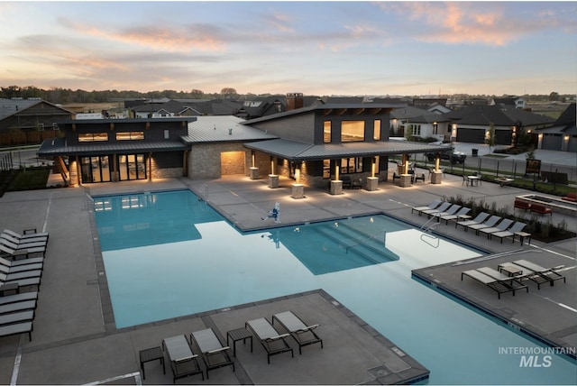 community pool with fence, a patio, a residential view, and outdoor lounge area