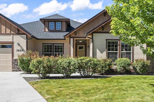 3924 E Forked Deer St, Boise, ID 83716 - craftsman-style house with board and batten siding, a shingled roof, a front yard, and an attached garage