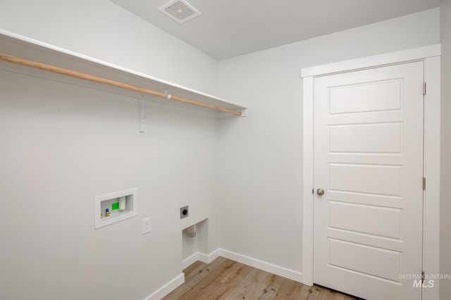 laundry room featuring electric dryer hookup, visible vents, washer hookup, light wood-style floors, and laundry area