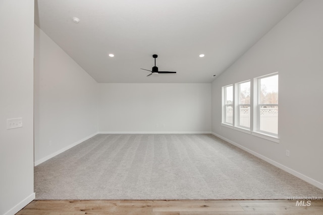 unfurnished room featuring baseboards, vaulted ceiling, recessed lighting, wood finished floors, and a ceiling fan