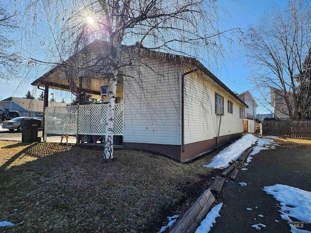 view of side of home featuring fence