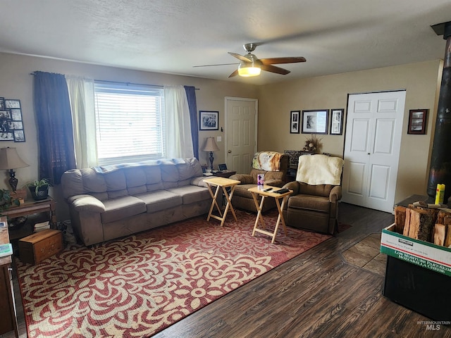 living room with dark wood-style floors and ceiling fan