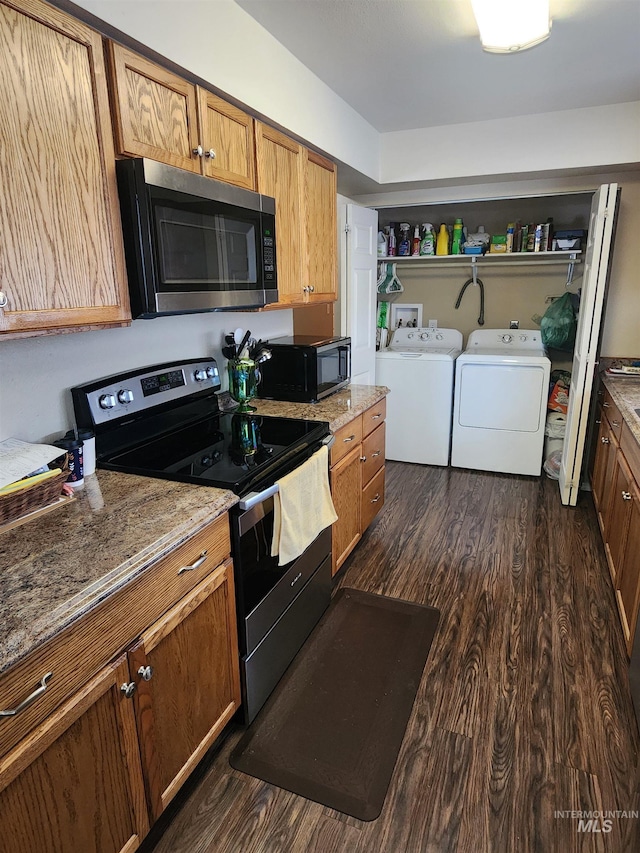 kitchen featuring light stone counters, dark wood finished floors, open shelves, stainless steel appliances, and washer and dryer