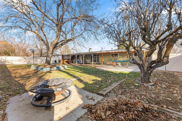 view of yard featuring an outdoor fire pit and a patio area