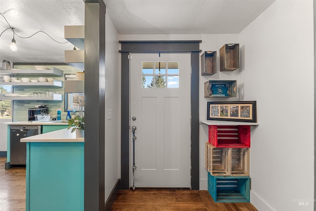 foyer entrance featuring dark hardwood / wood-style flooring and a textured ceiling