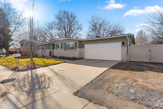 ranch-style house featuring a front yard and a garage