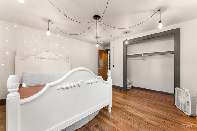 bedroom with hardwood / wood-style flooring and a closet