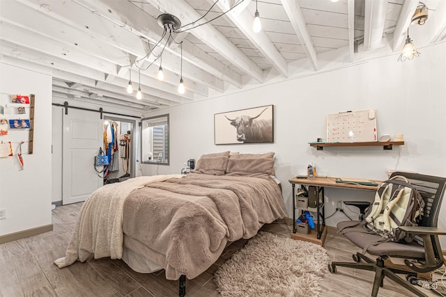 bedroom featuring a barn door, wood ceiling, and beamed ceiling