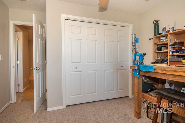 carpeted home office featuring a textured ceiling