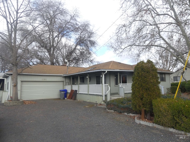 ranch-style home featuring a garage and covered porch