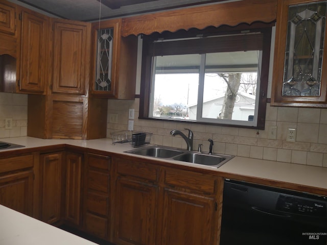 kitchen with black dishwasher, sink, and decorative backsplash