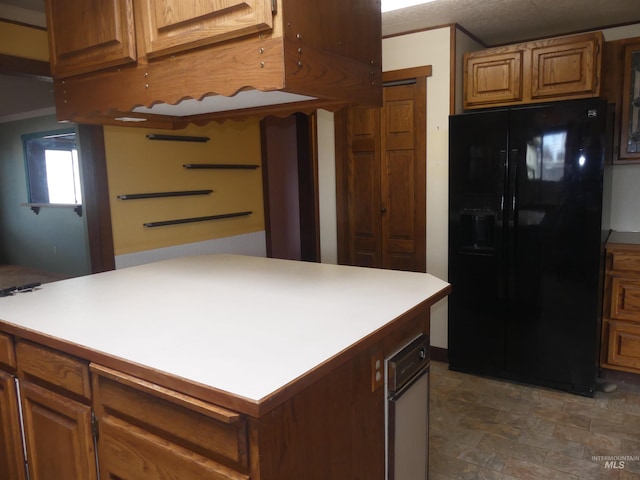 kitchen with black fridge with ice dispenser