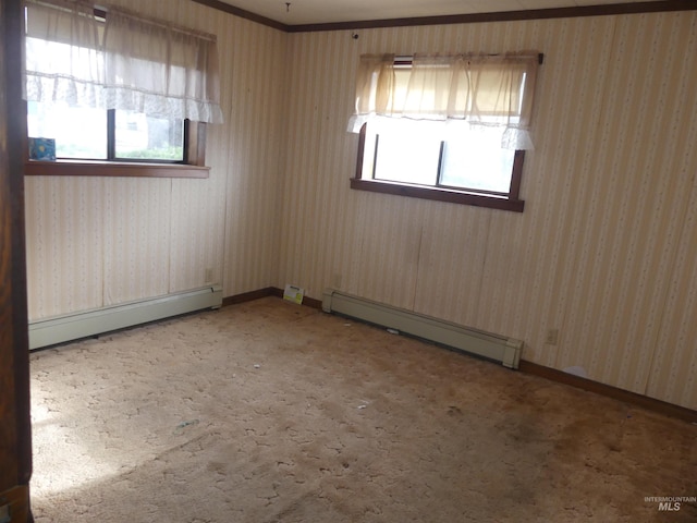 carpeted empty room featuring plenty of natural light and a baseboard heating unit