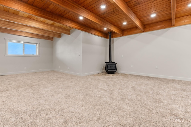 unfurnished living room featuring beam ceiling, carpet floors, and wooden ceiling