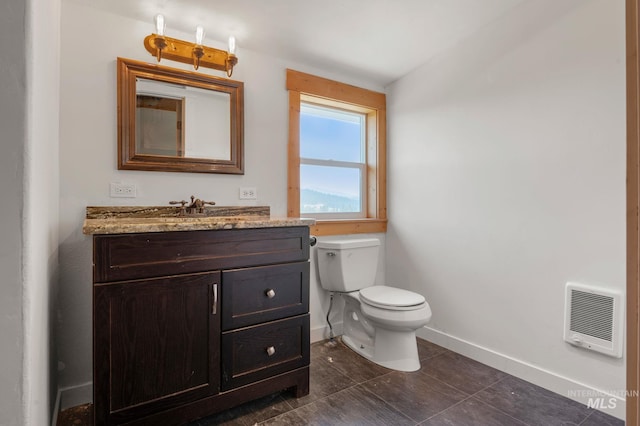 bathroom featuring vanity, toilet, and heating unit