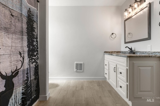 bathroom with hardwood / wood-style floors and vanity