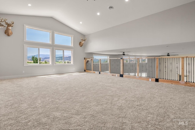 unfurnished living room with carpet flooring, high vaulted ceiling, and ceiling fan