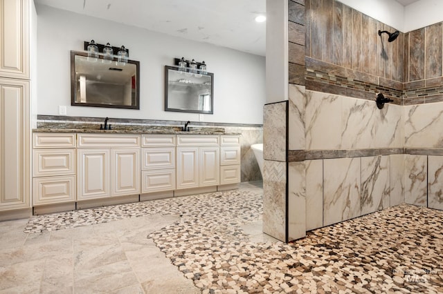 bathroom featuring vanity and tile walls