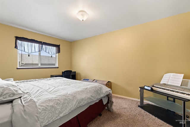 bedroom featuring carpet and baseboards