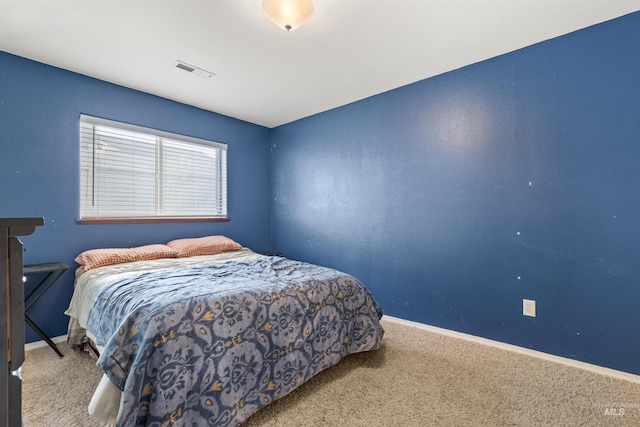 carpeted bedroom with visible vents and baseboards