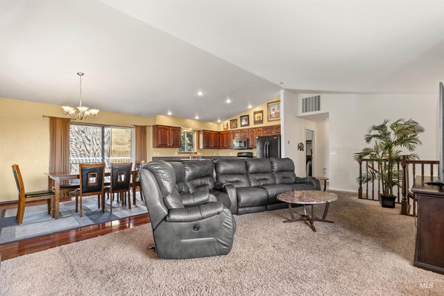 kitchen featuring a kitchen island, sink, lofted ceiling, and black appliances