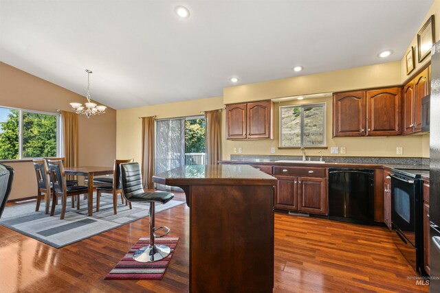 kitchen with a kitchen island, sink, and black appliances