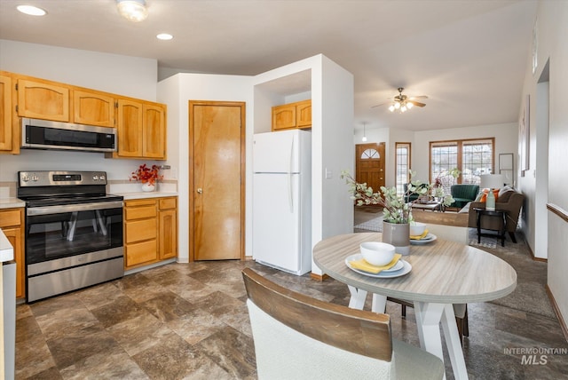 kitchen featuring appliances with stainless steel finishes, recessed lighting, open floor plan, and light countertops