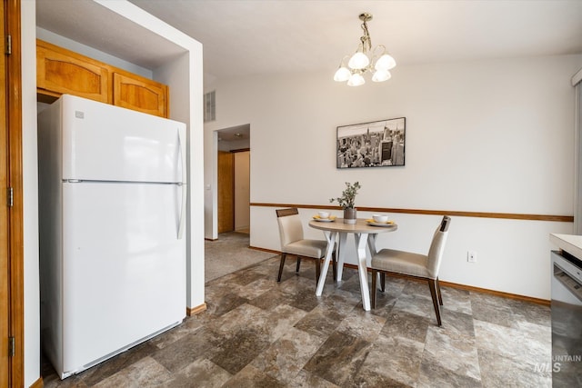 kitchen with baseboards, visible vents, freestanding refrigerator, stainless steel dishwasher, and a notable chandelier