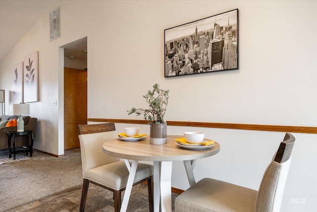 dining room featuring carpet flooring, visible vents, and baseboards