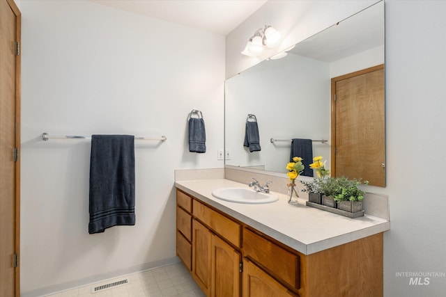 bathroom featuring visible vents, vanity, and tile patterned floors