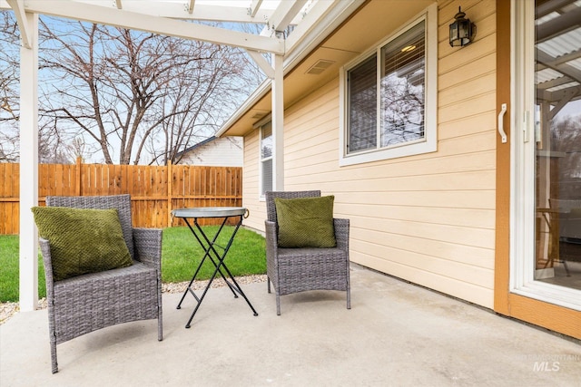 view of patio / terrace featuring fence