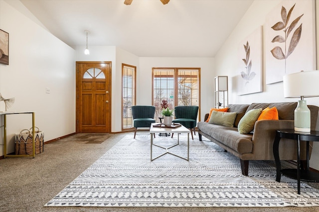 carpeted living area featuring a ceiling fan, lofted ceiling, and baseboards