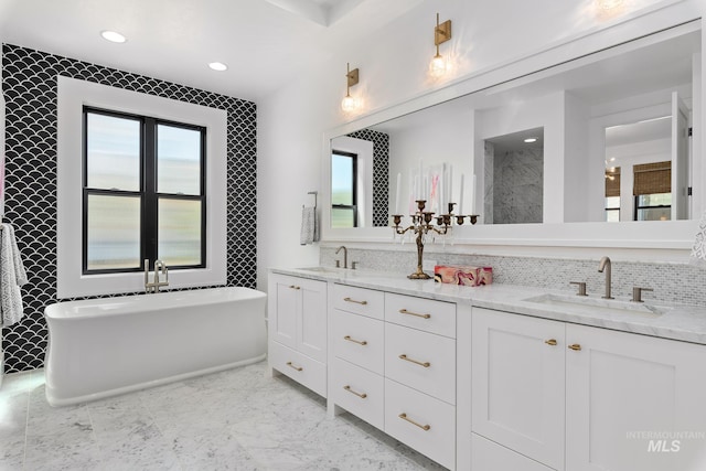 bathroom featuring vanity, independent shower and bath, and tasteful backsplash