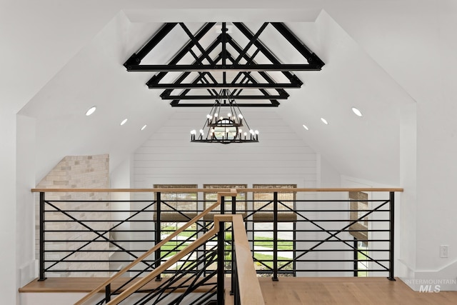 interior space featuring high vaulted ceiling, wood-type flooring, and a chandelier