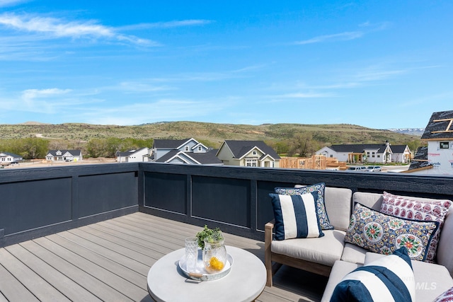 wooden deck with a mountain view and an outdoor hangout area