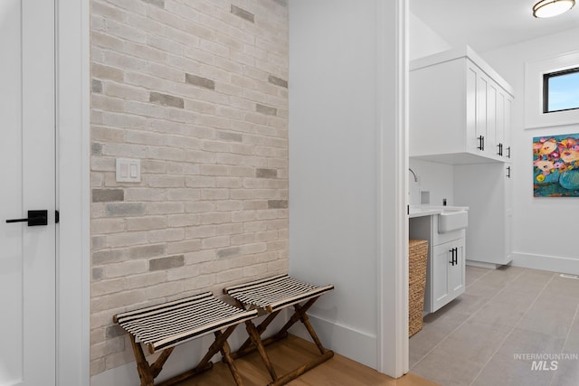 interior space with sink and light tile patterned flooring