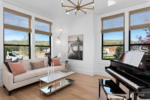 living room featuring light hardwood / wood-style flooring and a chandelier