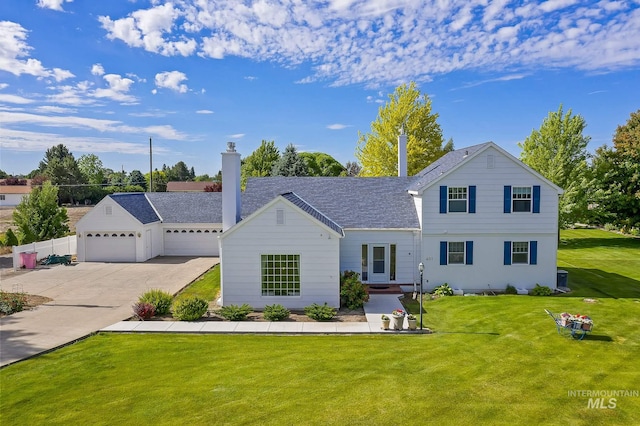 view of front of house with a garage and a front lawn