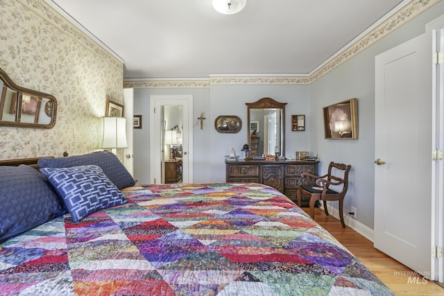 bedroom featuring crown molding and light hardwood / wood-style flooring