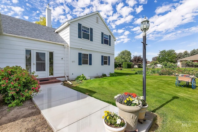 rear view of property with a yard