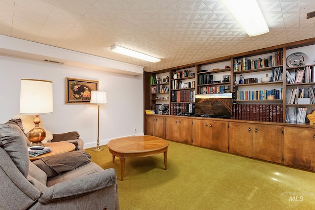 living area with light carpet and built in features