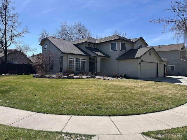 traditional-style house with an attached garage, driveway, a front lawn, and fence