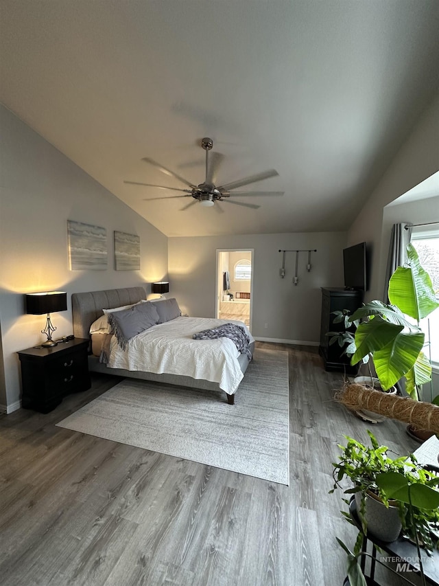 bedroom with lofted ceiling, baseboards, wood finished floors, and ceiling fan