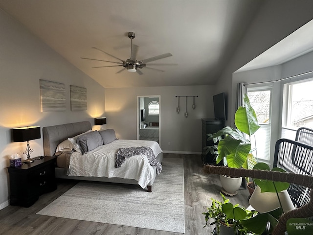 bedroom with baseboards, vaulted ceiling, wood finished floors, and a ceiling fan