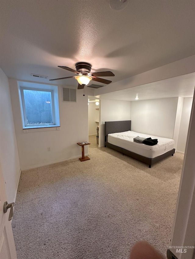 carpeted bedroom featuring ceiling fan, baseboards, and visible vents