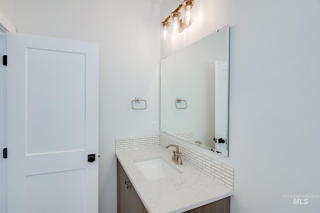 bathroom featuring vanity and decorative backsplash