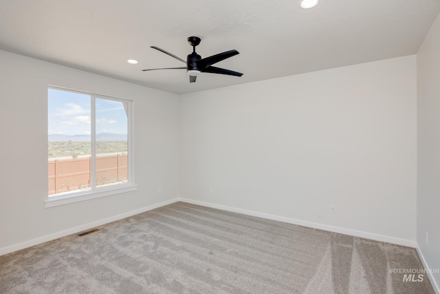 carpeted empty room with ceiling fan